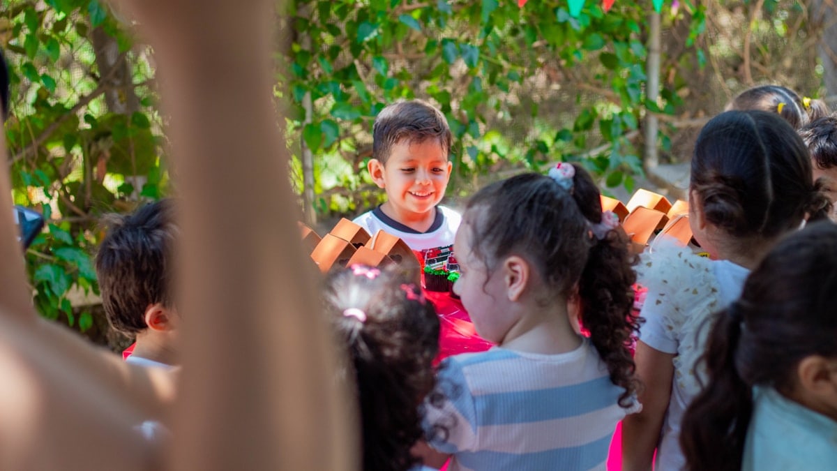 a group of young children standing next to each other